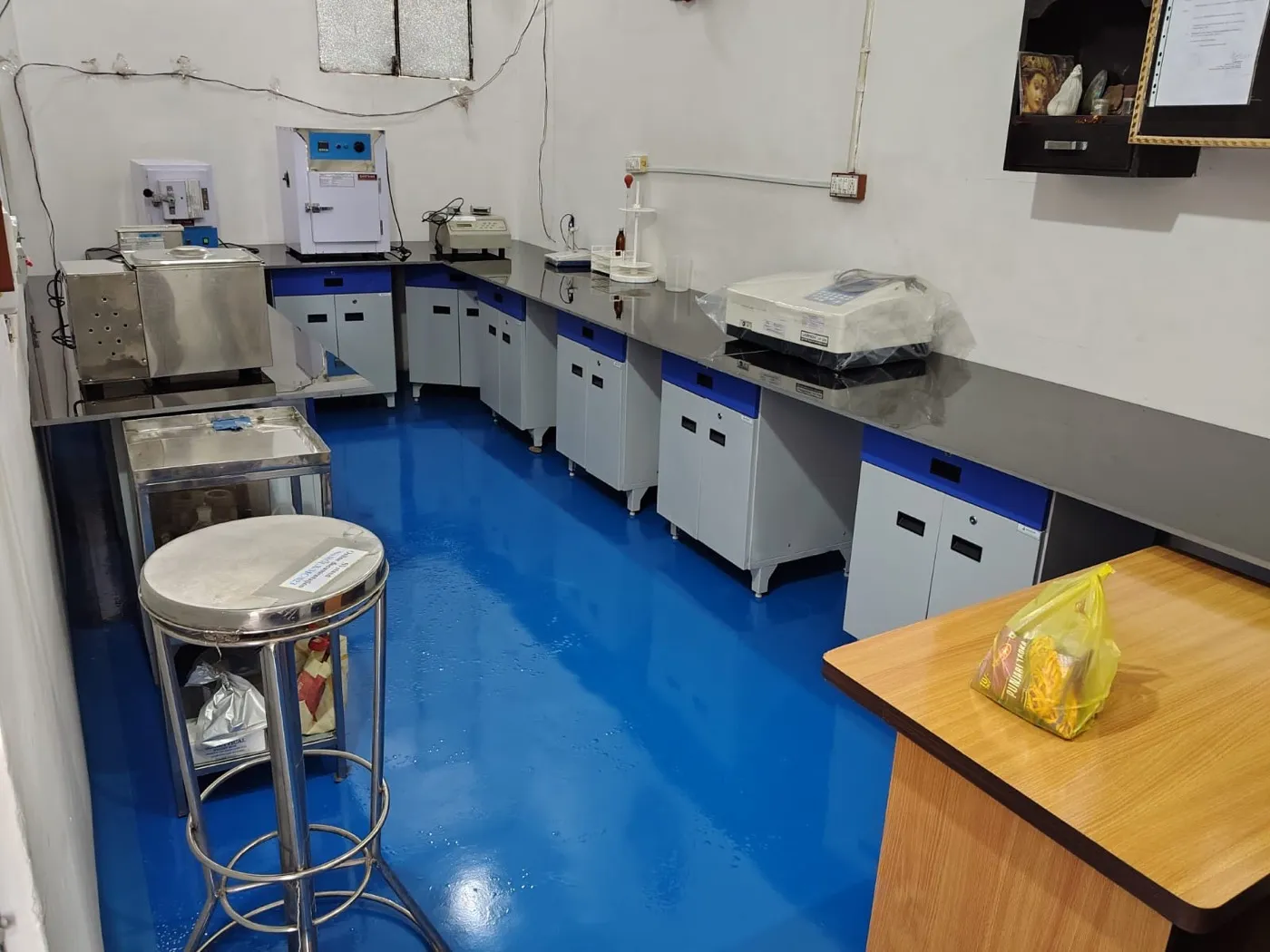 Quality control laboratory at the Tahliwal works, with balances, a hot air oven and testing instruments along the bench