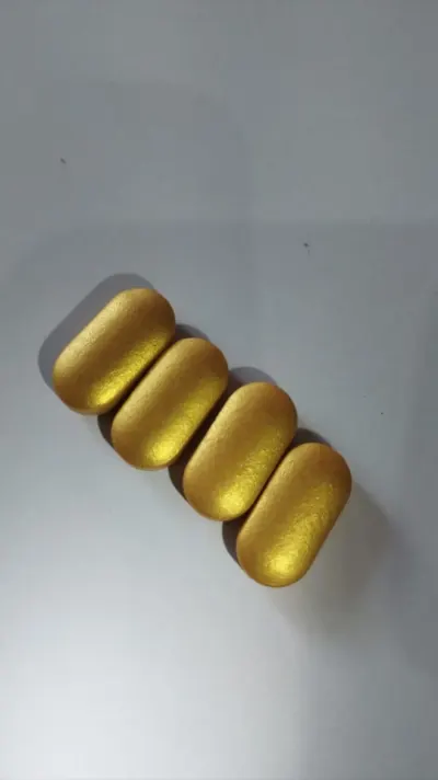 Metallic gold film coated caplets