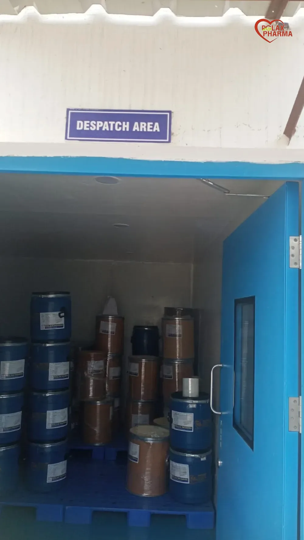 Despatch area with Rglax Pharma branded drums stacked on pallets